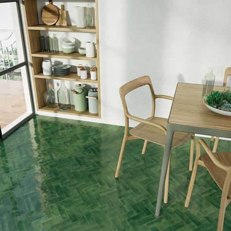 Shelves with kitchen accessories. Table and chairs on a tiled floor.