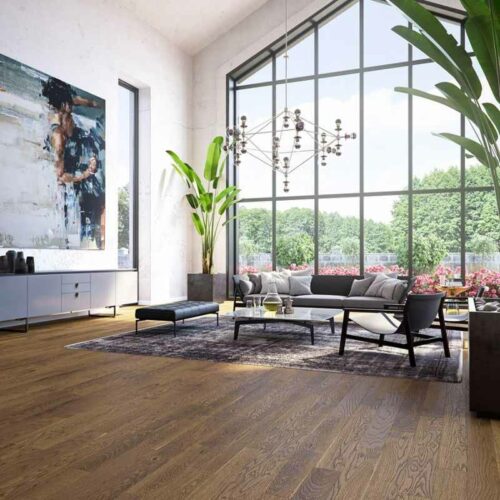 Wooden flooring in a living room next to a large window.