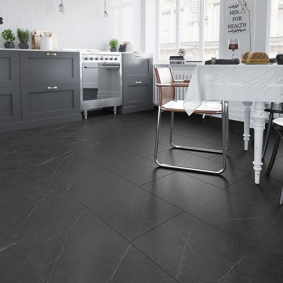 A kitchen with black LVT flooring