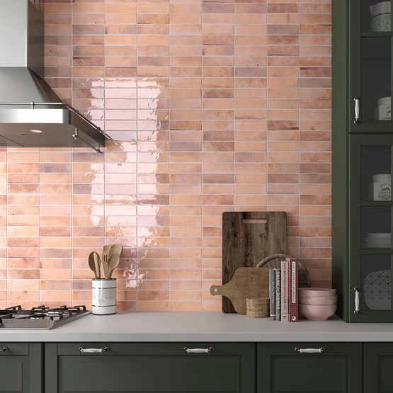 A kitchen with a pink brick tile splashback