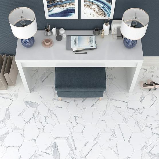 A white desk space with marble effect hexagonal floor tiles and dark blue/grey walls
