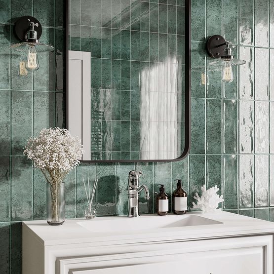 A bathroom sink, tap and basin with textured blue wall tiles