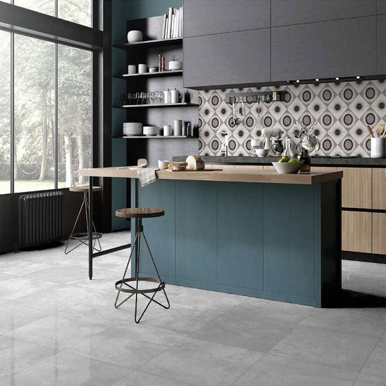 A modern kitchen with a grey and blue colour scheme and grey porcelain square wall and floor tiles