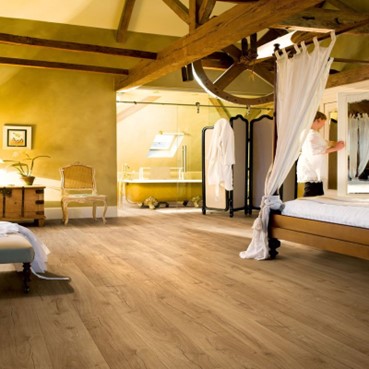 A bedroom with laminate flooring in it.