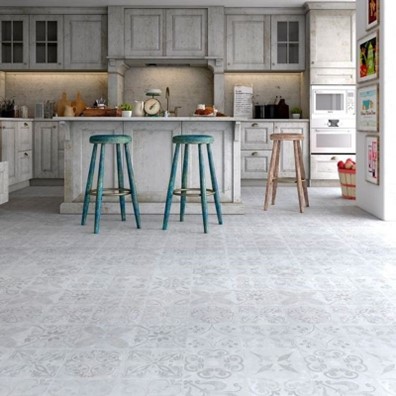 A kitchen with white cabinets, blue stools and stone effect, patterned laminate flooring.