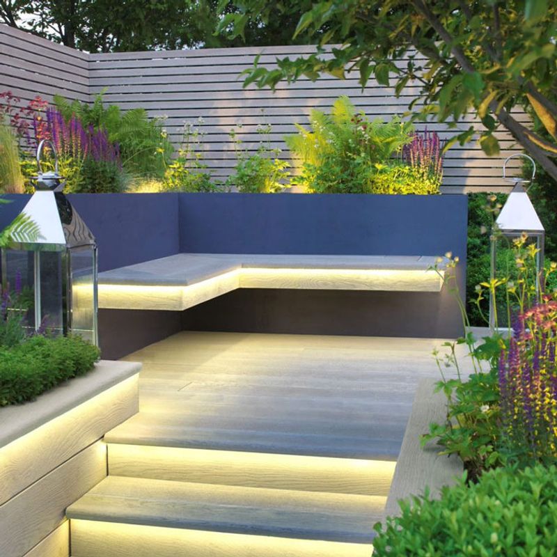 Decking with stairs, seating and lighting in the evening. 