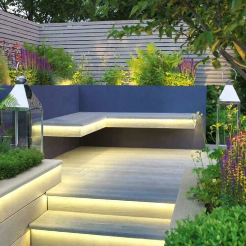 Decking with stairs, seating and lighting in the evening.
