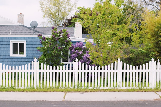 Blue house with a white picket fence