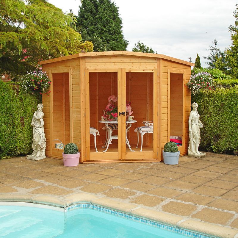 Summerhouse next to a garden swimming pool