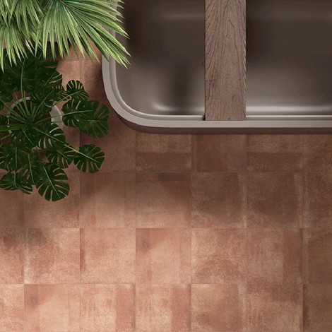 Terracotta colour bathroom floor tiles.